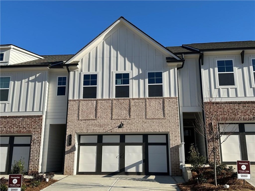 View of front of home with brick siding, board and