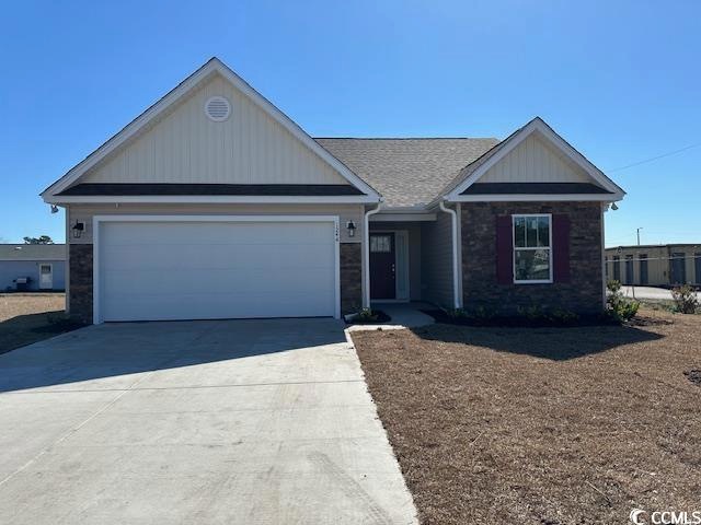 Ranch-style house featuring concrete driveway, sto