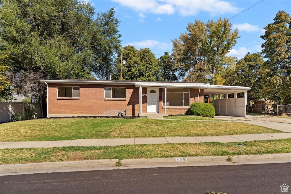 Single story home with a carport, concrete driveway, and brick siding