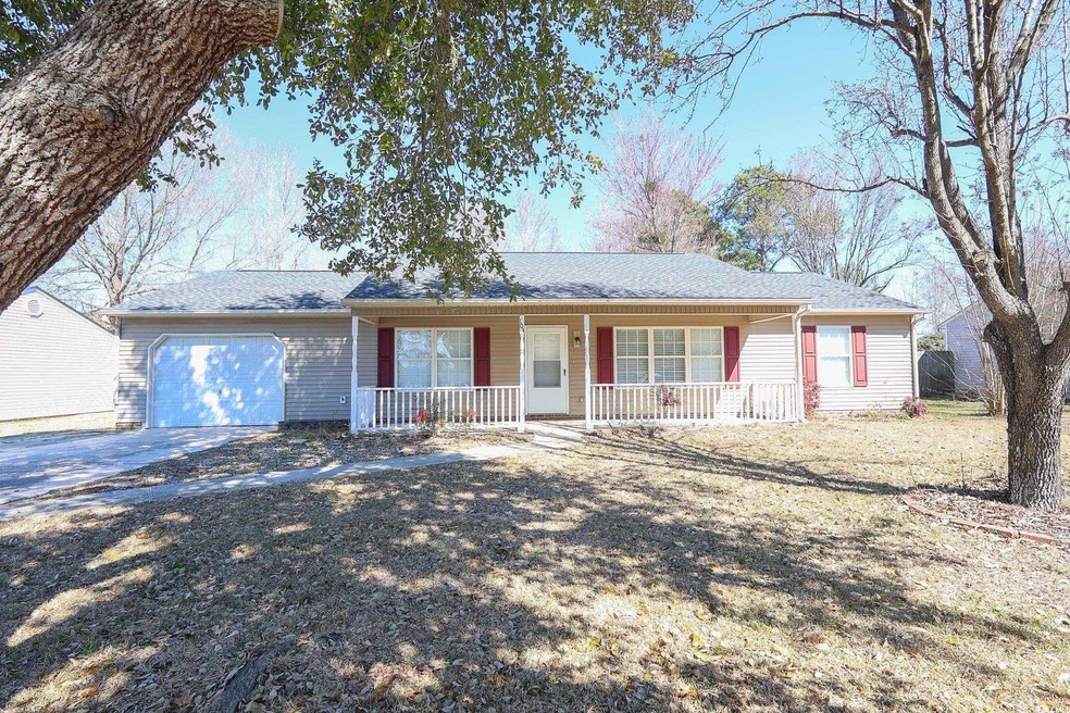 Single story home featuring a garage, covered porc