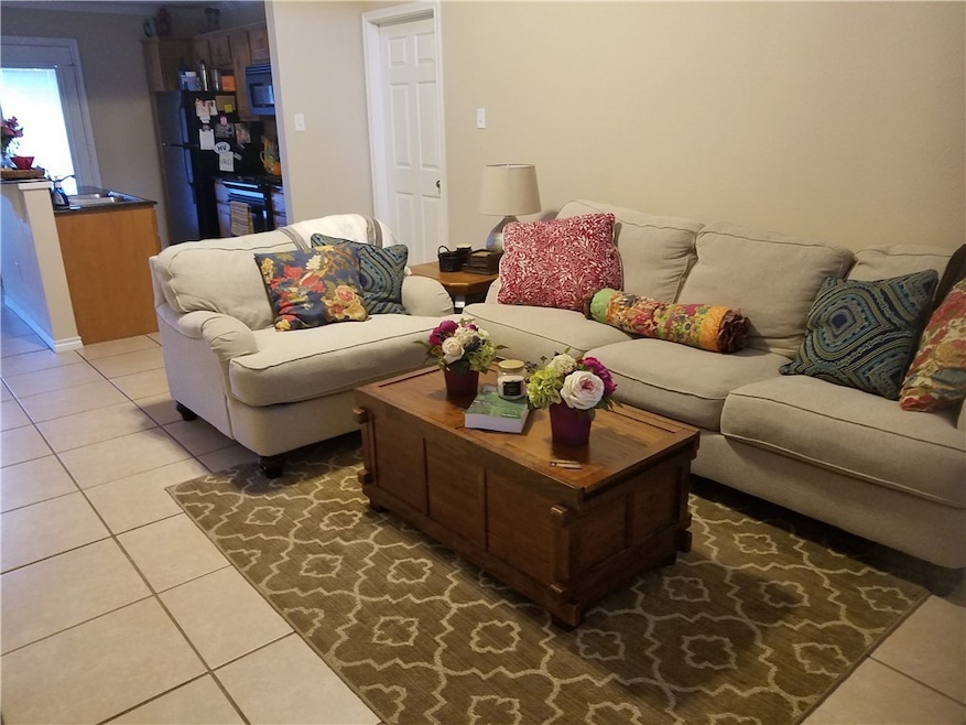 Living room with tile flooring, Vaulted ceiling.