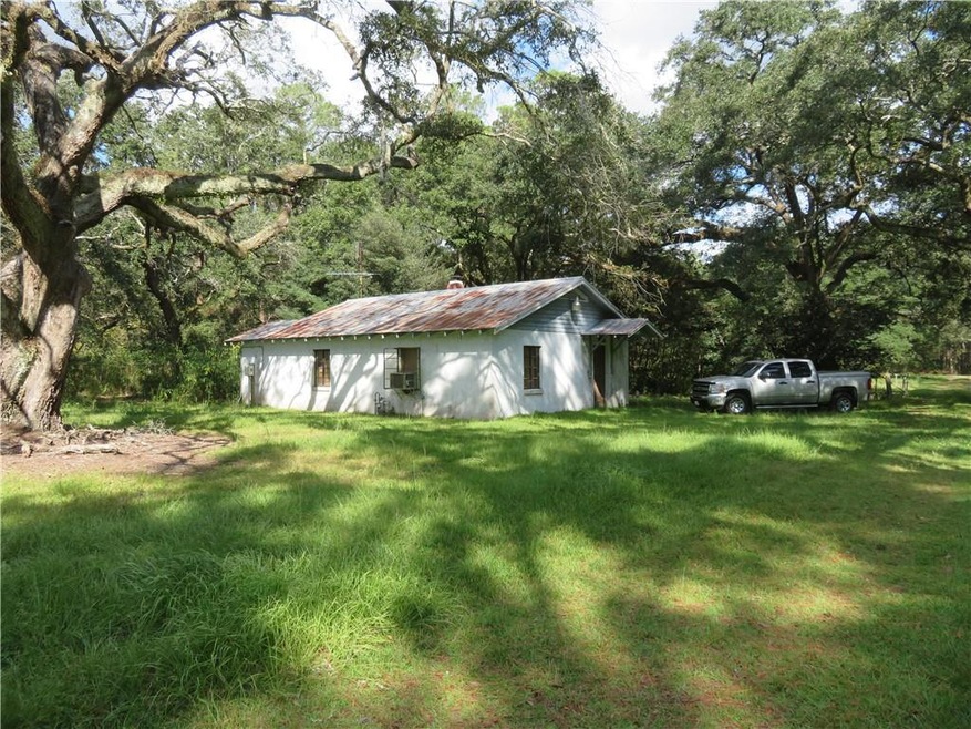 View of green lawn featuring cooling unit