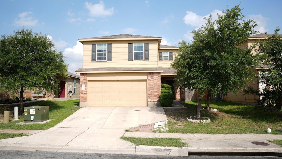 View of front of home featuring driveway, an atta
