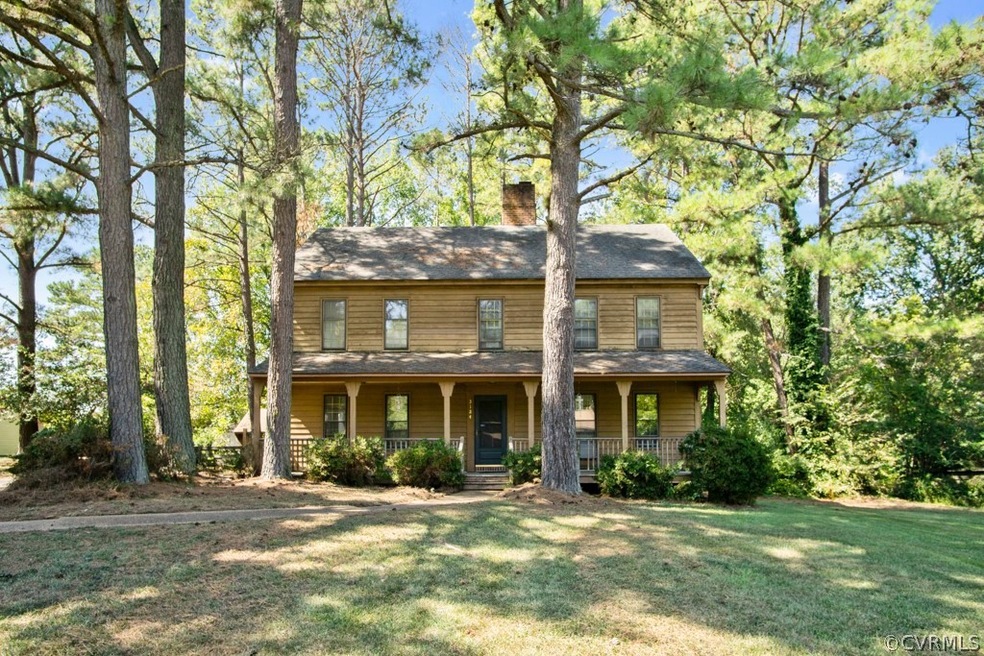 Front covered country porch, mature trees and a st