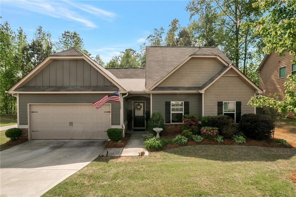 Craftsman inspired home featuring a garage and a f