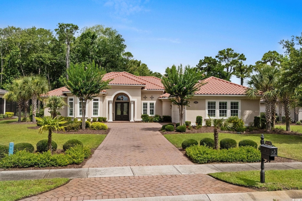 Mediterranean / spanish-style home with french doors, a garage, decorative driveway, stucco siding, and a front yard