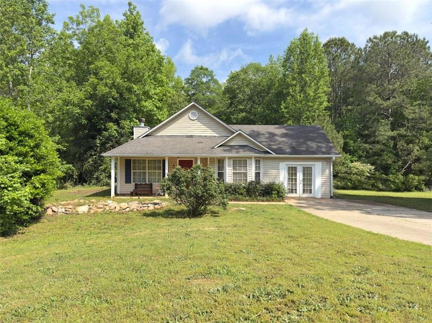 Single story home with french doors, a front lawn,