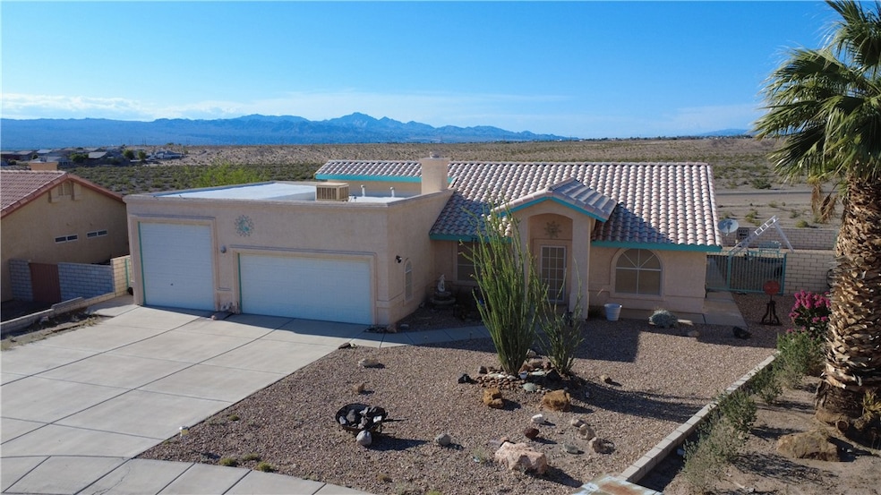 View of front facade with stucco siding, a garage,