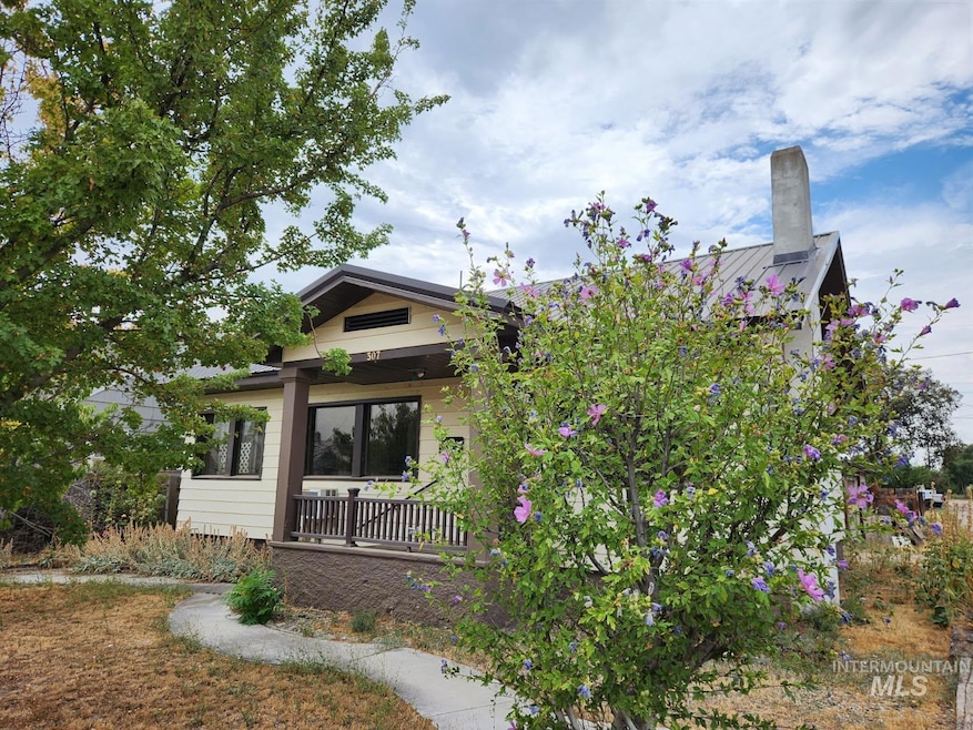 Back of property featuring covered porch and a chimney