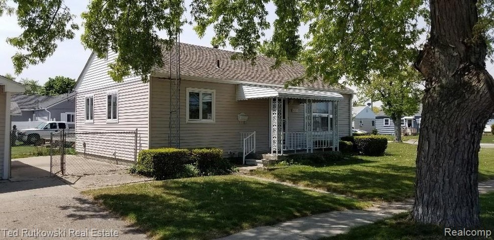FRONT VIEW WITH NEWER ROOF, COVERED PORCH & FENCED