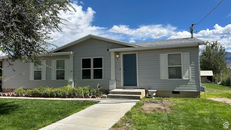 View of front of property featuring crawl space and a front yard