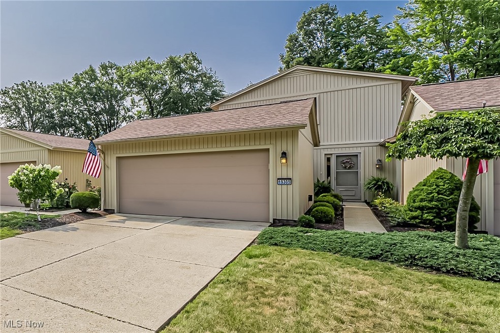 View of front of property featuring a garage and a front lawn