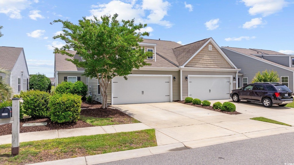 View of front of property featuring driveway and a