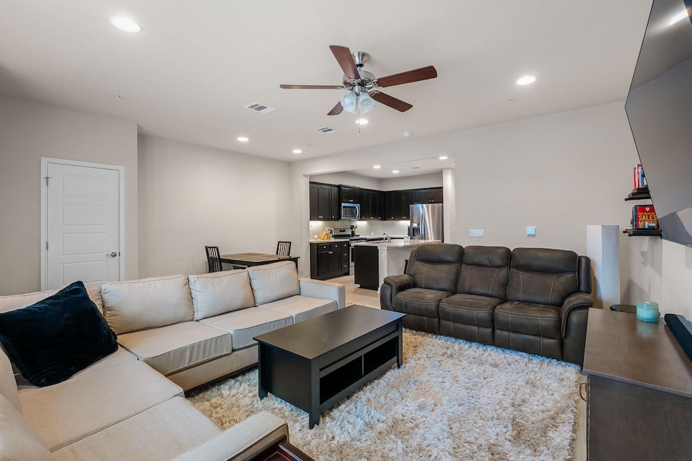 Living room with visible vents, ceiling fan, and 