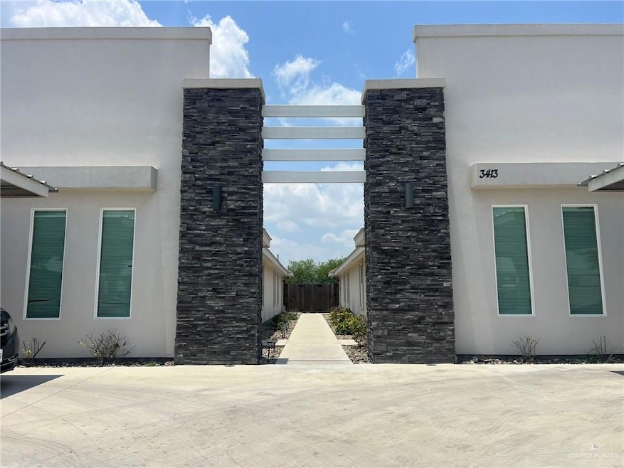 View of side of property featuring stucco siding and stone siding