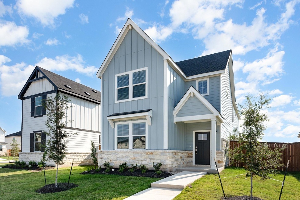 Welcome home! The paved walkway leads up to the quaint covered front porch with a welcoming modern front door.