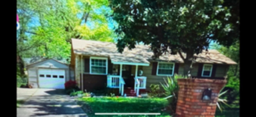 View of front of property featuring an outbuilding