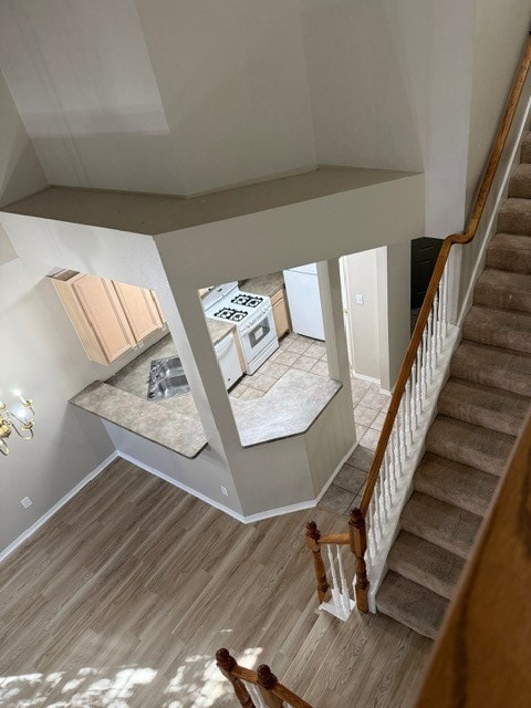 Stairway featuring wood finished floors and baseboards
