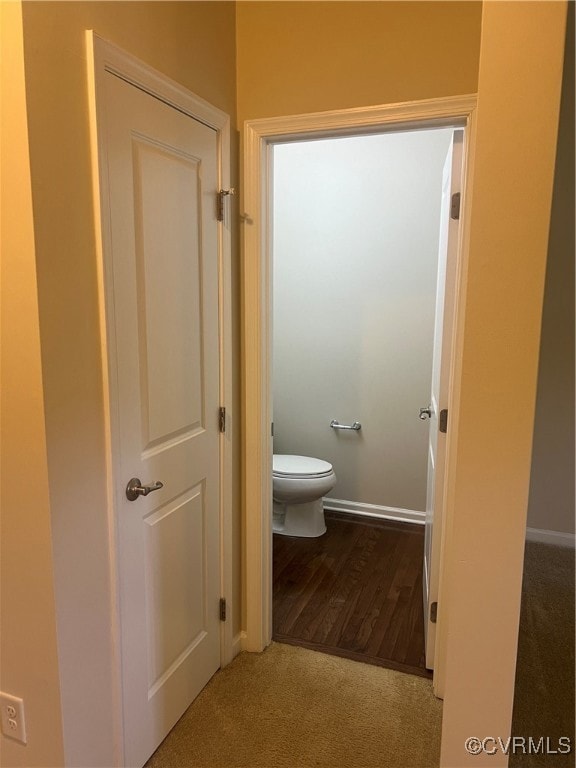 Bathroom with toilet and wood finished floors
