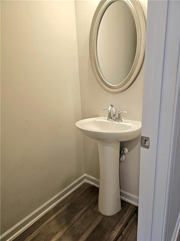 Bathroom with wood finished floors and baseboards