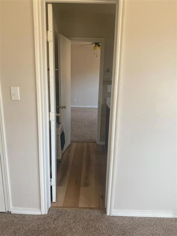 Corridor with carpet flooring and wood finished floors