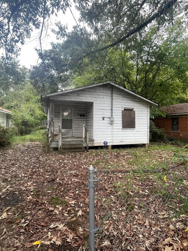 Back of property with a porch