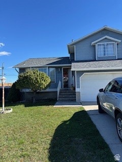 Tri-level home featuring a front lawn, an attached garage, and driveway