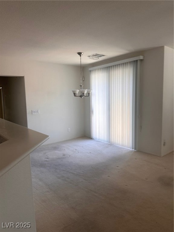 Unfurnished dining area with visible vents, light