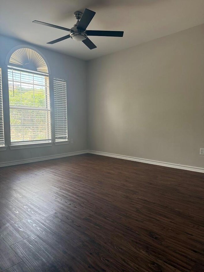 Empty room with dark wood-style flooring and ceil