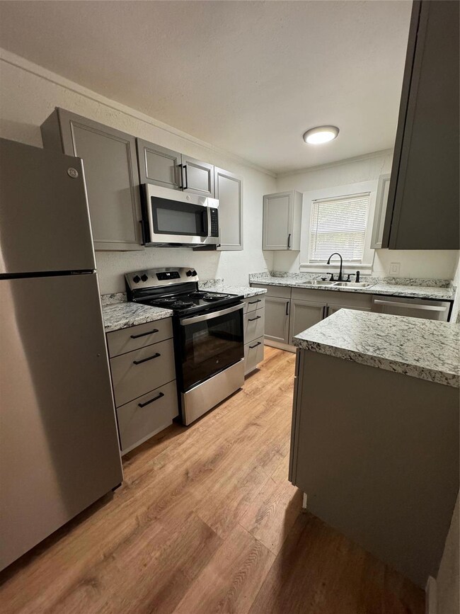 Kitchen with light hardwood / wood-style floors, g