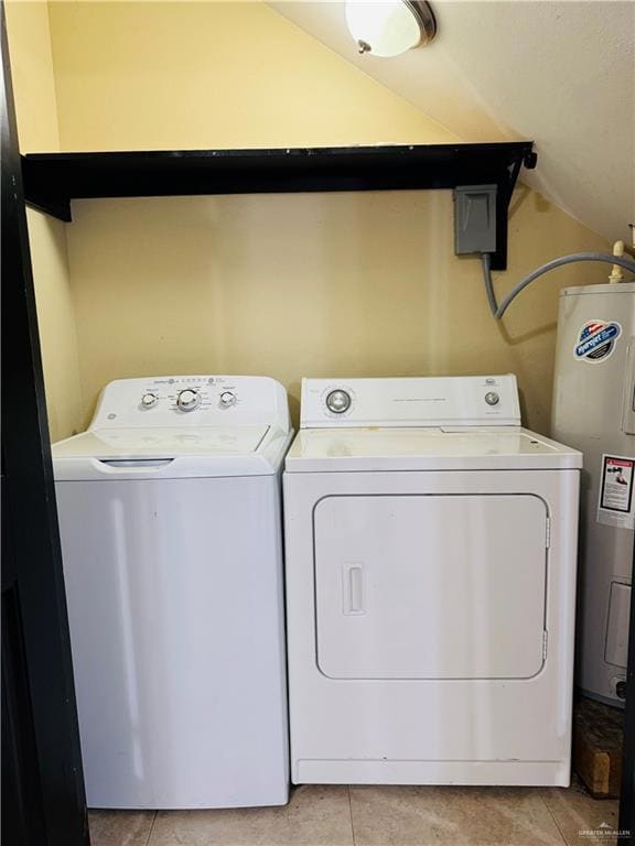 Clothes washing area with laundry area, water heater, light tile patterned flooring, and washing machine and clothes dryer