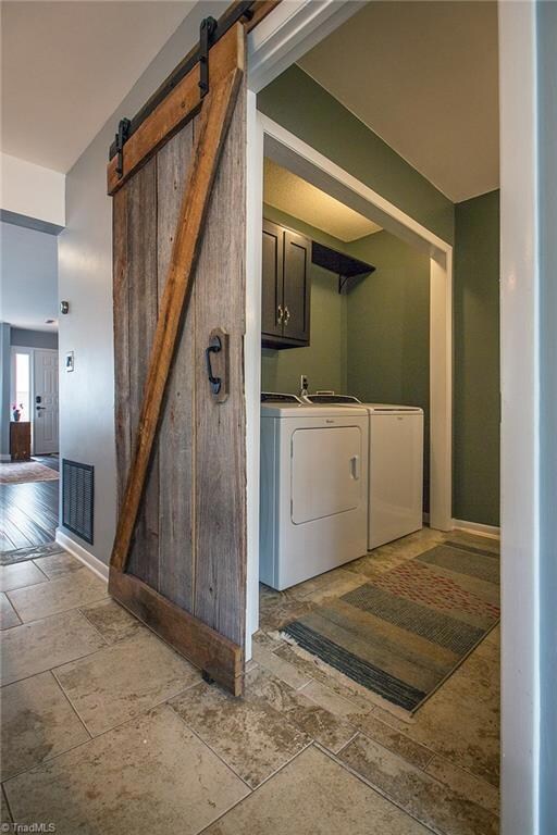Laundry room with sliding barn door.