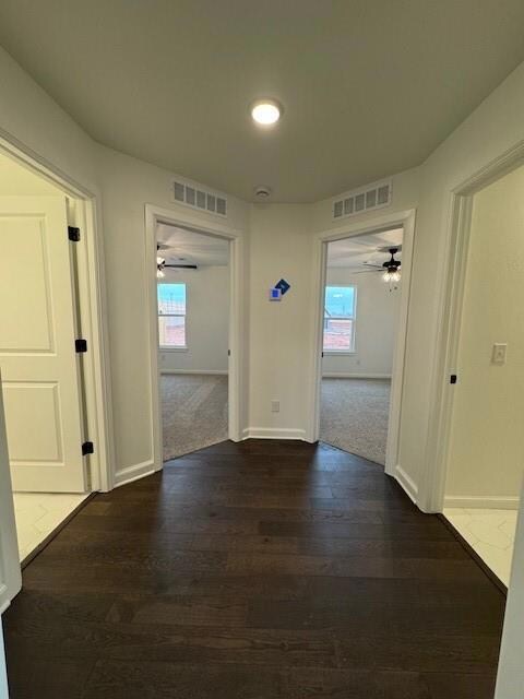 Corridor with dark hardwood / wood-style floors