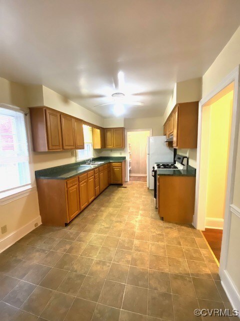 Kitchen with stainless steel gas stove, ceiling fa