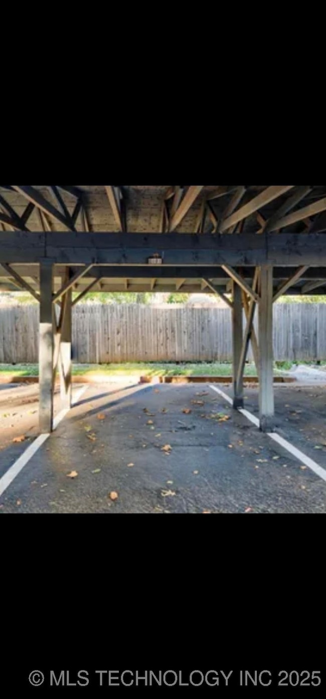 Covered parking lot featuring fence