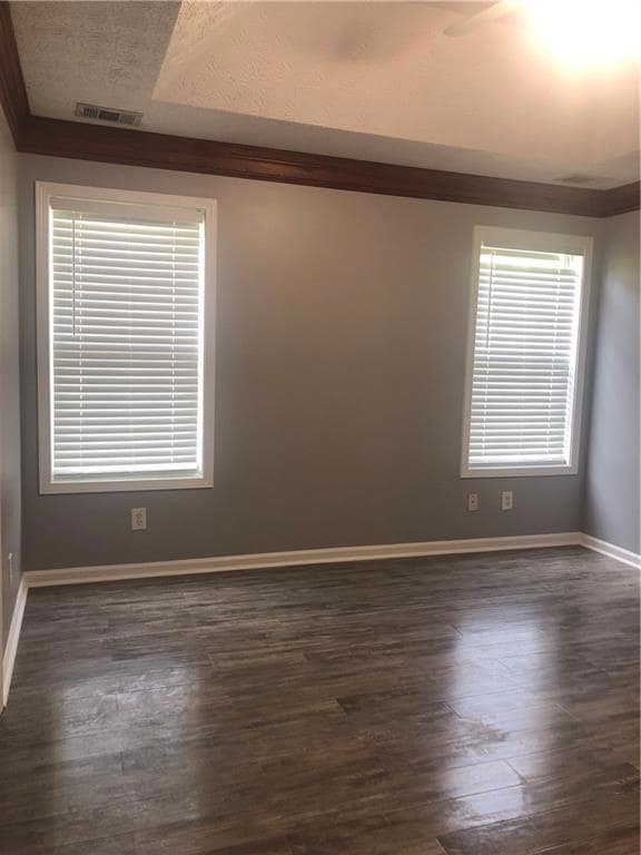 Unfurnished room dark wood-style flooring