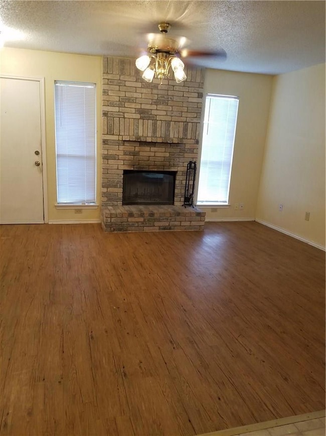 Unfurnished living room with ceiling fan, a textu