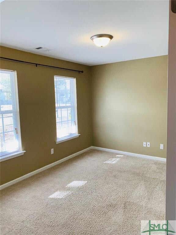 Separate living room with 2 windows looking out to
