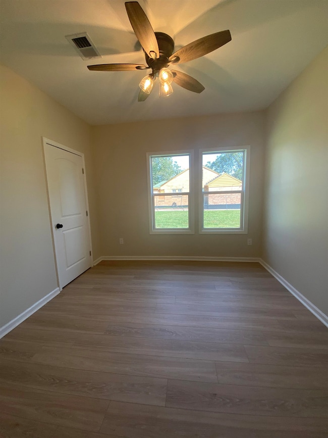 Unfurnished room featuring light wood-style flooring and a ceiling fan