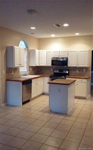 KITCHEN,TILE FLOORING CENTER ISLAND SS APPLIANCES
