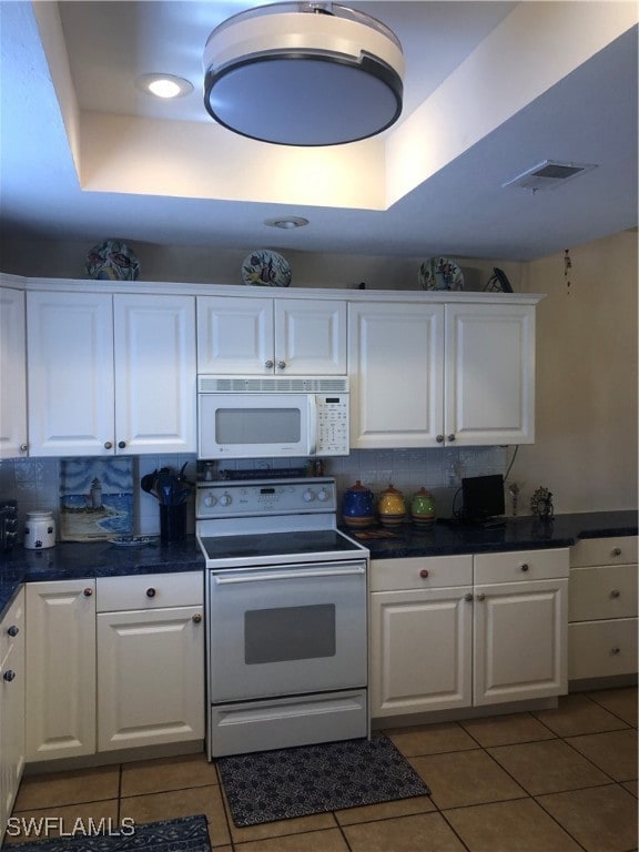 Kitchen featuring visible vents, stove, dark count