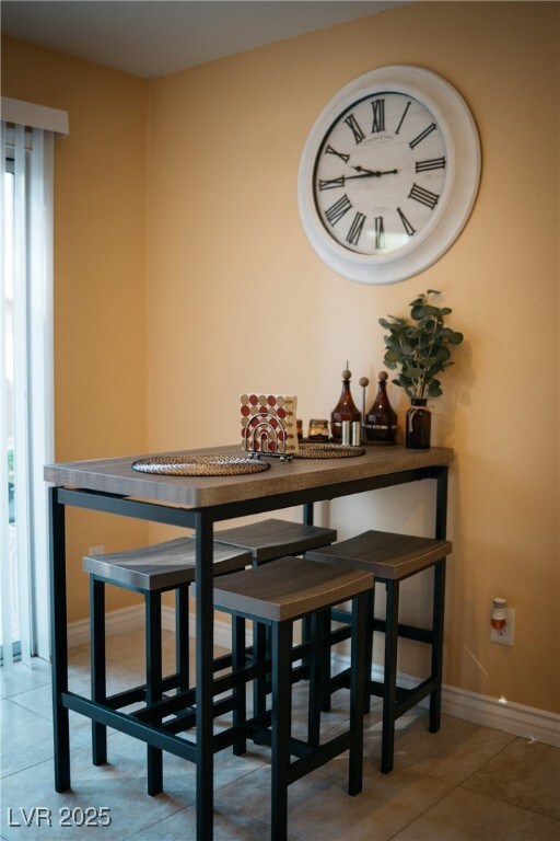 Tiled dining space with baseboards