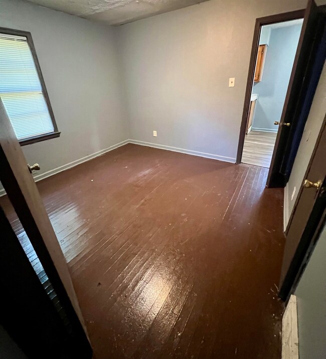 Spare room featuring wood-type flooring