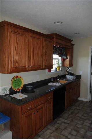 View of the sink area with a window overlooking the back yard.