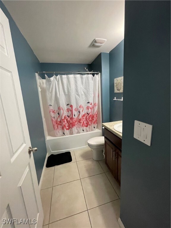 Full bath featuring vanity, shower / tub combo wit