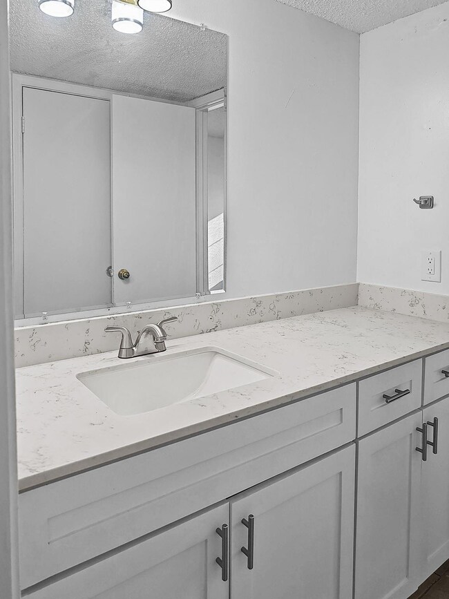 Bathroom with vanity and a textured ceiling