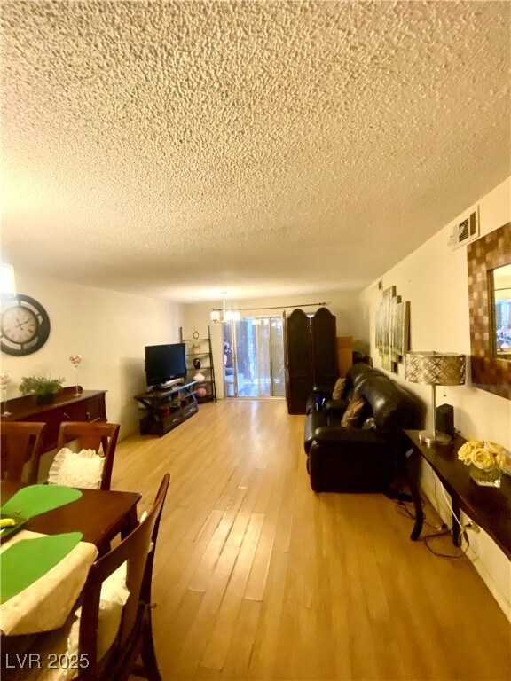 Living room featuring a textured ceiling and wood