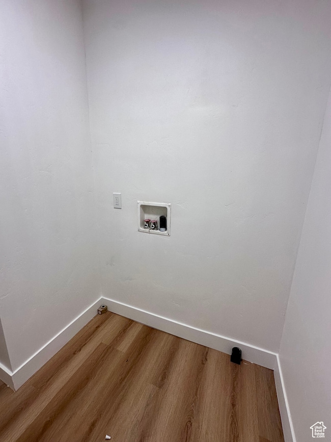Laundry area with washer hookup and wood finished floors