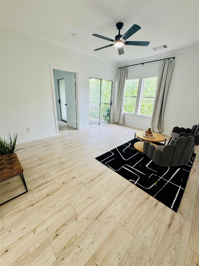 Living room featuring ceiling fan, visible vents,