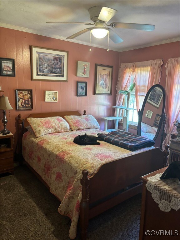 Carpeted bedroom with crown molding and a ceiling